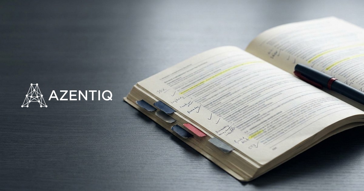 An open reference manual on a desk, tabbed and annotated by hand, with passages highlighted